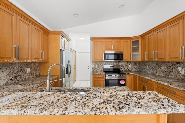 11581 SW 10th Ct, Pembroke Pines, FL 33025 - kitchen with appliances with stainless steel finishes, light stone countertops, lofted ceiling, glass insert cabinets, and tasteful backsplash