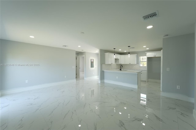 626 Hobart Ave S, Lehigh Acres, FL 33974 - unfurnished living room featuring recessed lighting and light marble finish flooring