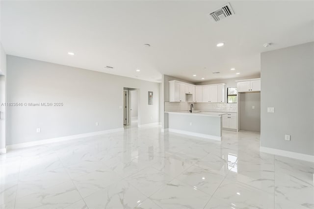 626 Hobart Ave S, Lehigh Acres, FL 33974 - unfurnished living room with light marble finish floors and recessed lighting