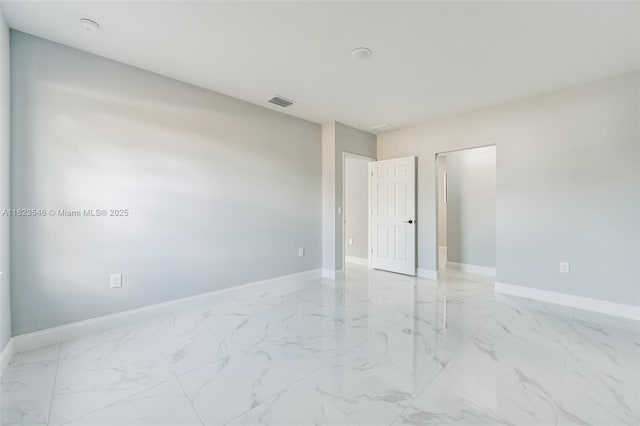 626 Hobart Ave S, Lehigh Acres, FL 33974 - empty room with light marble finish flooring and baseboards