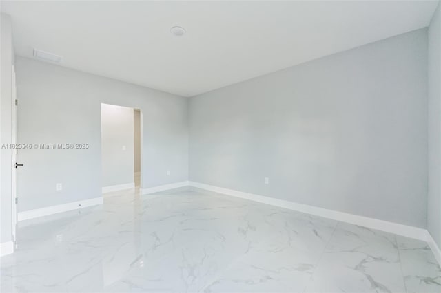 626 Hobart Ave S, Lehigh Acres, FL 33974 - spare room featuring baseboards and light marble finish floors