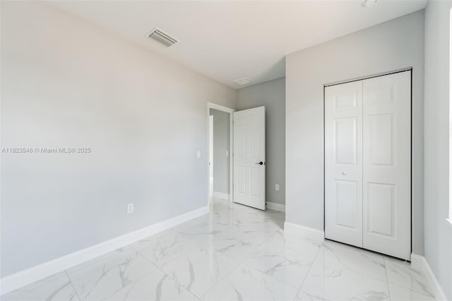 626 Hobart Ave S, Lehigh Acres, FL 33974 - unfurnished bedroom with light marble finish flooring and a closet