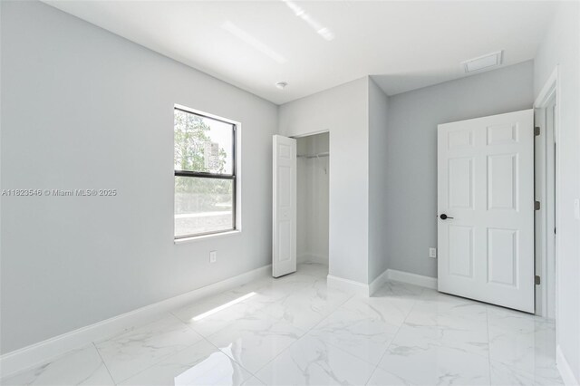 626 Hobart Ave S, Lehigh Acres, FL 33974 - unfurnished bedroom with light marble finish flooring and a closet
