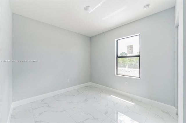 626 Hobart Ave S, Lehigh Acres, FL 33974 - spare room with light marble finish floors and a smoke detector