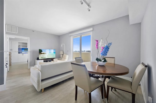 1621 Bay Rd Unit Ph3, Miami Beach, FL 33139 - dining space with light wood-style floors and track lighting