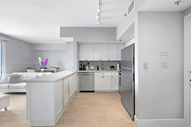 1621 Bay Rd Unit Ph3, Miami Beach, FL 33139 - kitchen featuring stainless steel appliances, rail lighting, a peninsula, and open floor plan