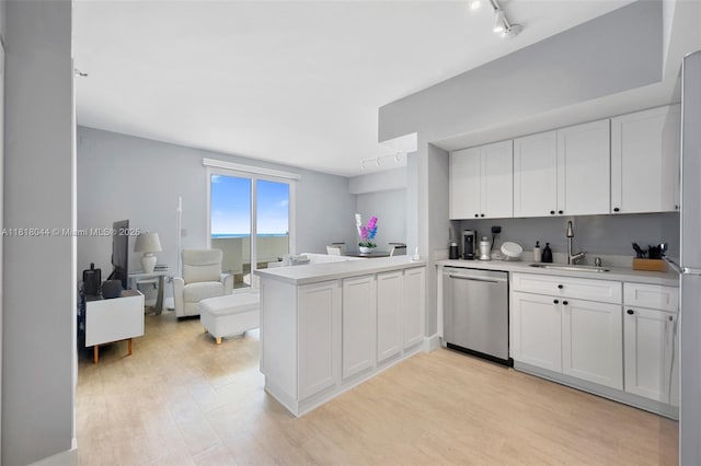 1621 Bay Rd Unit Ph3, Miami Beach, FL 33139 - kitchen featuring dishwasher, light wood finished floors, and white cabinetry