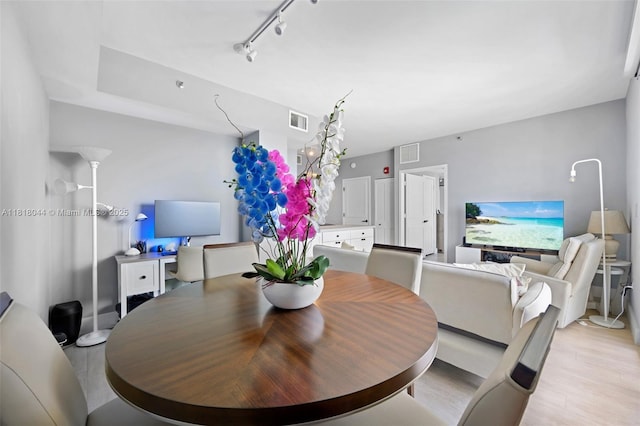 1621 Bay Rd Unit Ph3, Miami Beach, FL 33139 - dining room featuring light wood finished floors and rail lighting