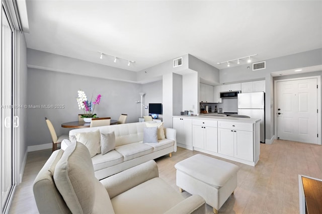 1621 Bay Rd Unit Ph3, Miami Beach, FL 33139 - living room featuring track lighting and light wood-style flooring