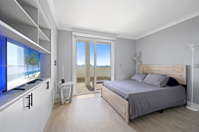 1621 Bay Rd Unit Ph3, Miami Beach, FL 33139 - bedroom with light wood-type flooring, access to outside, and crown molding