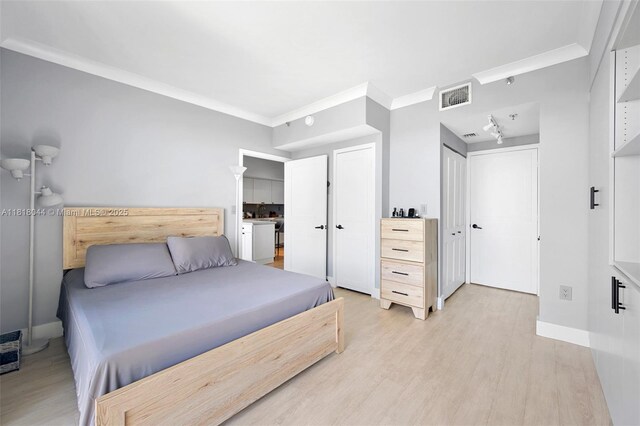 1621 Bay Rd Unit Ph3, Miami Beach, FL 33139 - bedroom featuring light wood-type flooring and crown molding