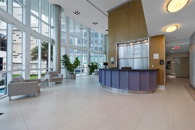 480 NE 30th St Unit 1402, Miami, FL 33137 - reception featuring a high ceiling and a wall of windows