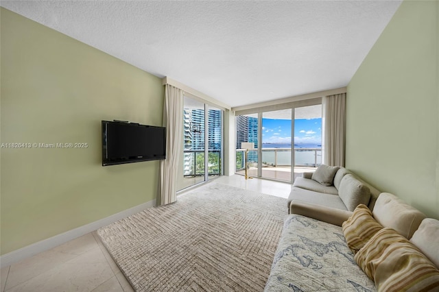 480 NE 30th St Unit 1402, Miami, FL 33137 - living area with expansive windows and a textured ceiling