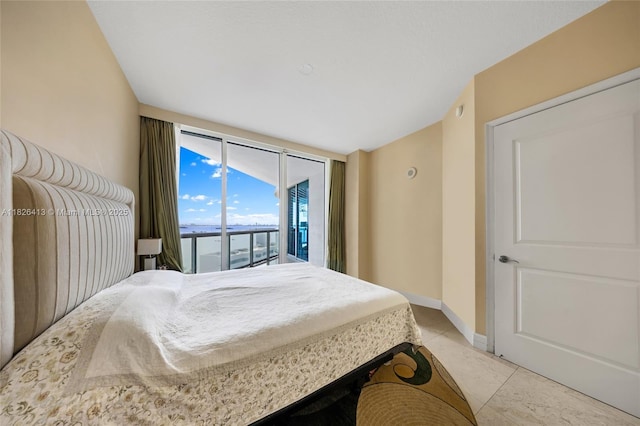 480 NE 30th St Unit 1402, Miami, FL 33137 - bedroom featuring access to exterior, expansive windows, and light tile patterned floors