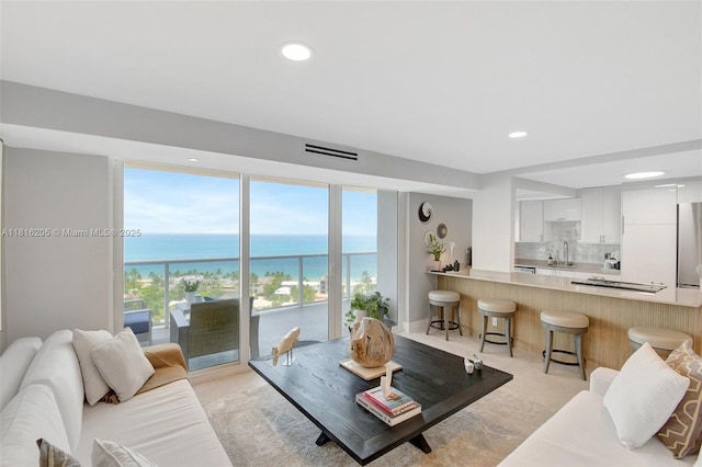 2701 N Ocean Blvd Unit 18A, Fort Lauderdale, FL 33308 - living area with healthy amount of natural light, a water view, and recessed lighting