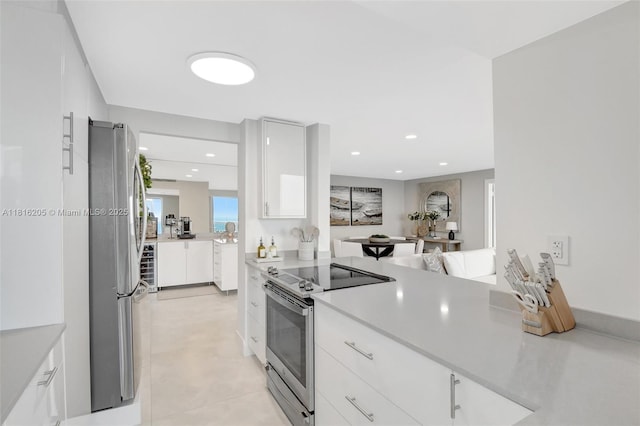 2701 N Ocean Blvd Unit 18A, Fort Lauderdale, FL 33308 - kitchen featuring stainless steel appliances, white cabinets, light countertops, and recessed lighting