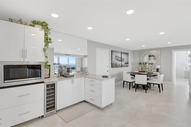 2701 N Ocean Blvd Unit 18A, Fort Lauderdale, FL 33308 - kitchen featuring built in microwave, beverage cooler, a peninsula, plenty of natural light, and recessed lighting