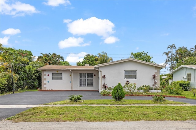 6441 NW 26th St, Sunrise, FL 33313 - ranch-style home featuring stucco siding, driveway, and a front lawn