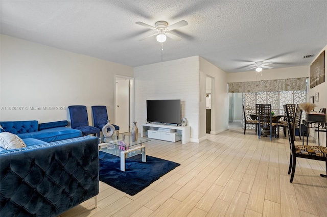 6441 NW 26th St, Sunrise, FL 33313 - living area with ceiling fan, a textured ceiling, and light wood-type flooring