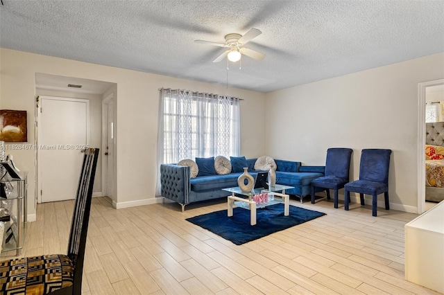 6441 NW 26th St, Sunrise, FL 33313 - living room with a ceiling fan, plenty of natural light, a textured ceiling, and wood finished floors