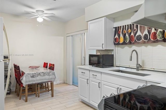 6441 NW 26th St, Sunrise, FL 33313 - kitchen with black appliances, ceiling fan, white cabinets, and light countertops