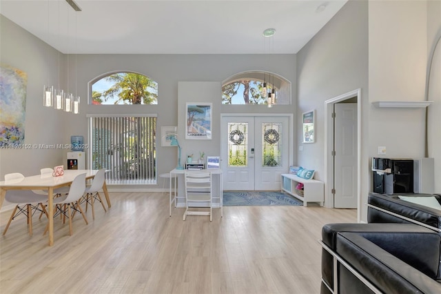 1137 SW Lighthouse Dr, Palm City, FL 34990 - entryway featuring a high ceiling, light wood finished floors, plenty of natural light, french doors, and a chandelier