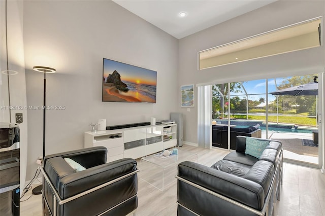 1137 SW Lighthouse Dr, Palm City, FL 34990 - living area featuring recessed lighting, light wood-style floors, and a high ceiling