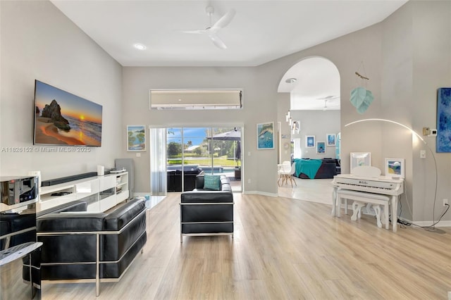 1137 SW Lighthouse Dr, Palm City, FL 34990 - living area with a ceiling fan, wood finished floors, arched walkways, and a towering ceiling