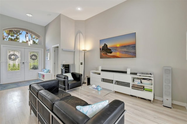1137 SW Lighthouse Dr, Palm City, FL 34990 - living area featuring french doors, a towering ceiling, and light wood finished floors
