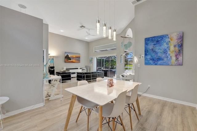 1137 SW Lighthouse Dr, Palm City, FL 34990 - dining room with light wood finished floors and a towering ceiling