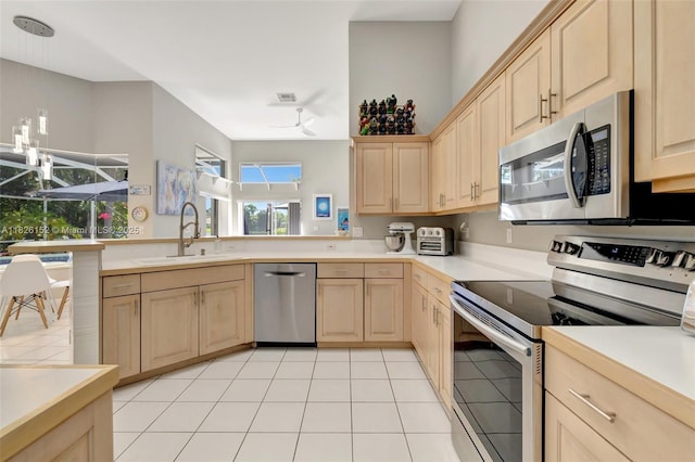 1137 SW Lighthouse Dr, Palm City, FL 34990 - kitchen featuring stainless steel appliances, light brown cabinetry, light countertops, and light tile patterned floors