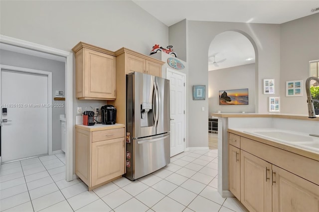 1137 SW Lighthouse Dr, Palm City, FL 34990 - kitchen featuring stainless steel fridge with ice dispenser, light brown cabinetry, light tile patterned flooring, and light countertops