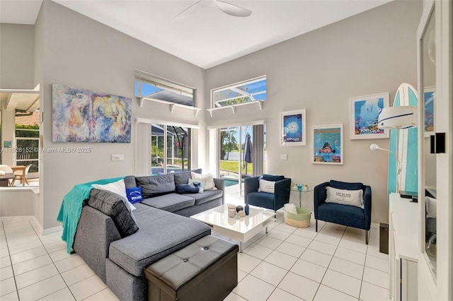 1137 SW Lighthouse Dr, Palm City, FL 34990 - living area with light tile patterned floors, a high ceiling, and a ceiling fan