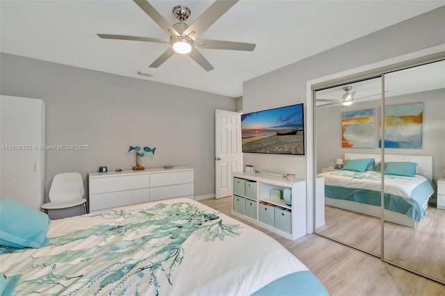 1137 SW Lighthouse Dr, Palm City, FL 34990 - bedroom featuring light wood-style flooring, a closet, and a ceiling fan