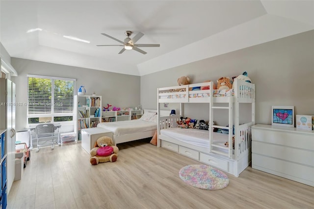 1137 SW Lighthouse Dr, Palm City, FL 34990 - bedroom with wood finished floors, a raised ceiling, and ceiling fan