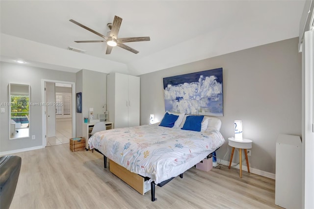 1137 SW Lighthouse Dr, Palm City, FL 34990 - bedroom with light wood-style flooring, a ceiling fan, and ensuite bath