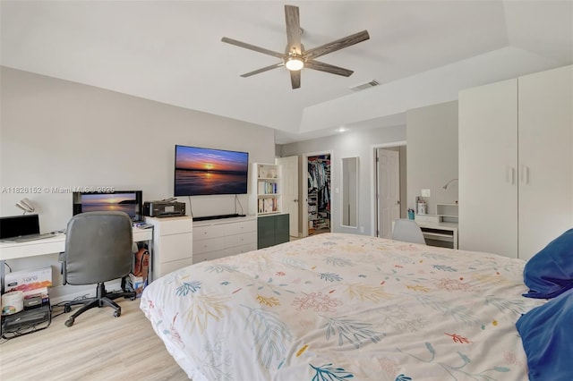 1137 SW Lighthouse Dr, Palm City, FL 34990 - bedroom with an office area, light wood-type flooring, a closet, ceiling fan, and a walk in closet