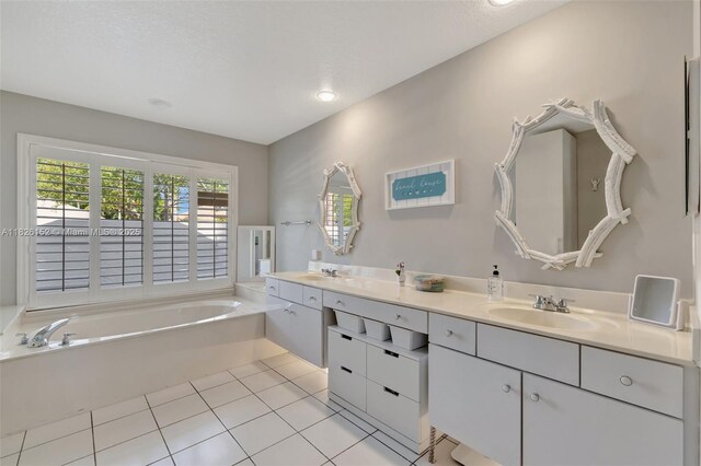 1137 SW Lighthouse Dr, Palm City, FL 34990 - bathroom with double vanity, a garden tub, and tile patterned floors
