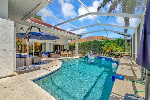 1137 SW Lighthouse Dr, Palm City, FL 34990 - swimming pool featuring an outdoor living space, a patio area, and glass enclosure