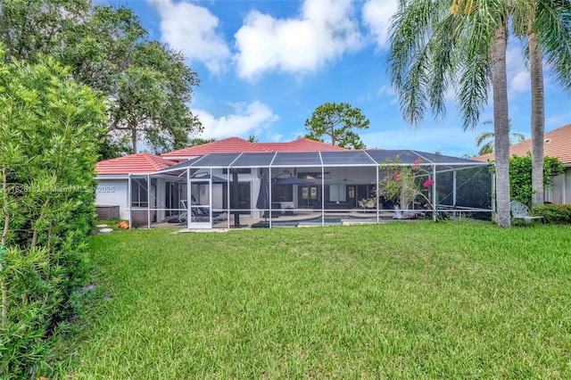 1137 SW Lighthouse Dr, Palm City, FL 34990 - rear view of property featuring a yard and glass enclosure