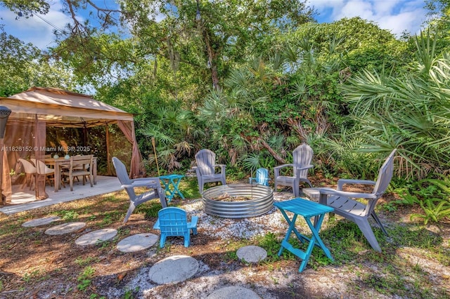 1137 SW Lighthouse Dr, Palm City, FL 34990 - view of yard with an outdoor fire pit, a gazebo, outdoor dining area, and a patio
