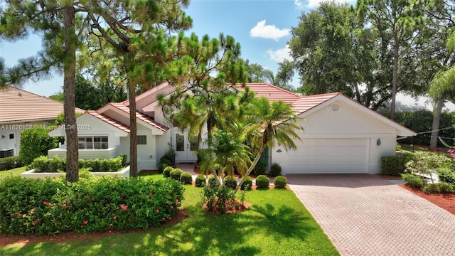 1137 SW Lighthouse Dr, Palm City, FL 34990 - mediterranean / spanish house with french doors, an attached garage, decorative driveway, a front lawn, and stucco siding