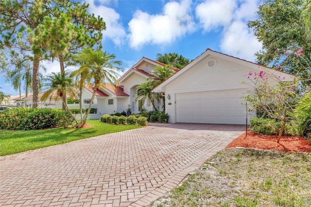 1137 SW Lighthouse Dr, Palm City, FL 34990 - view of front of house with a garage, decorative driveway, and stucco siding