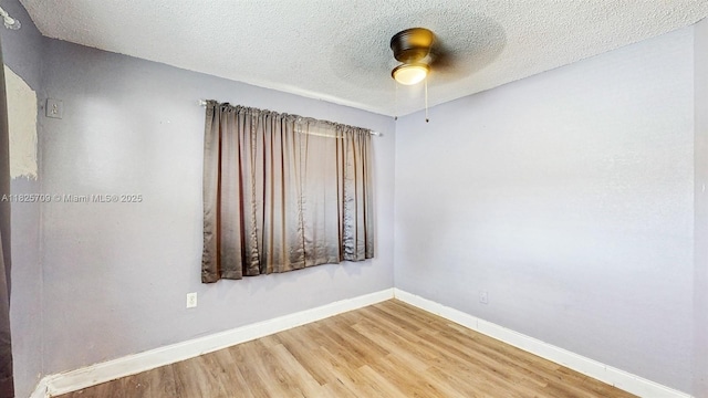 5637 SW 40th St, West Park, FL 33023 - spare room featuring wood finished floors, ceiling fan, and a textured ceiling