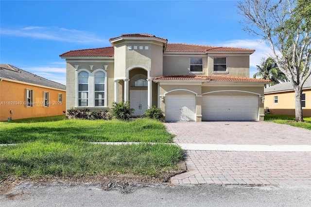 12986 SW 21st St, Miramar, FL 33027 - mediterranean / spanish-style home featuring stucco siding, a tile roof, decorative driveway, and an attached garage