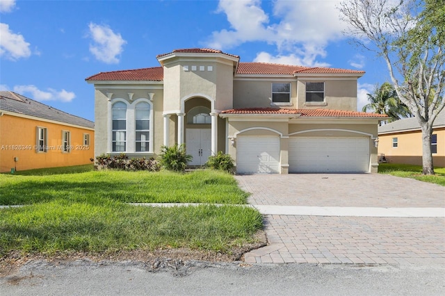 12986 SW 21st St, Miramar, FL 33027 - mediterranean / spanish-style house featuring stucco siding, a tiled roof, a garage, and decorative driveway