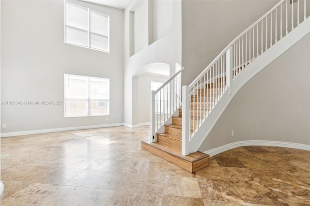 12986 SW 21st St, Miramar, FL 33027 - foyer entrance featuring arched walkways, stairs, stone finish flooring, and a high ceiling