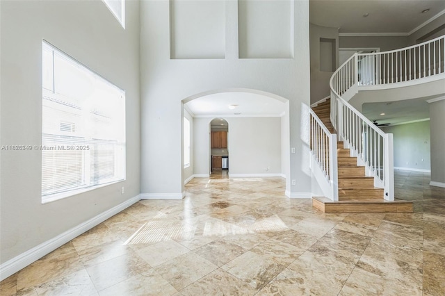 12986 SW 21st St, Miramar, FL 33027 - entryway with ornamental molding, stairs, a towering ceiling, and arched walkways
