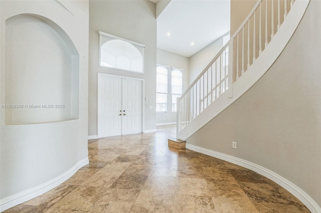 12986 SW 21st St, Miramar, FL 33027 - foyer featuring a towering ceiling, stairway, stone finish flooring, and arched walkways