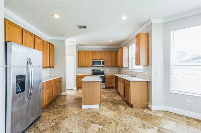 12986 SW 21st St, Miramar, FL 33027 - kitchen featuring appliances with stainless steel finishes, crown molding, a center island, light countertops, and recessed lighting